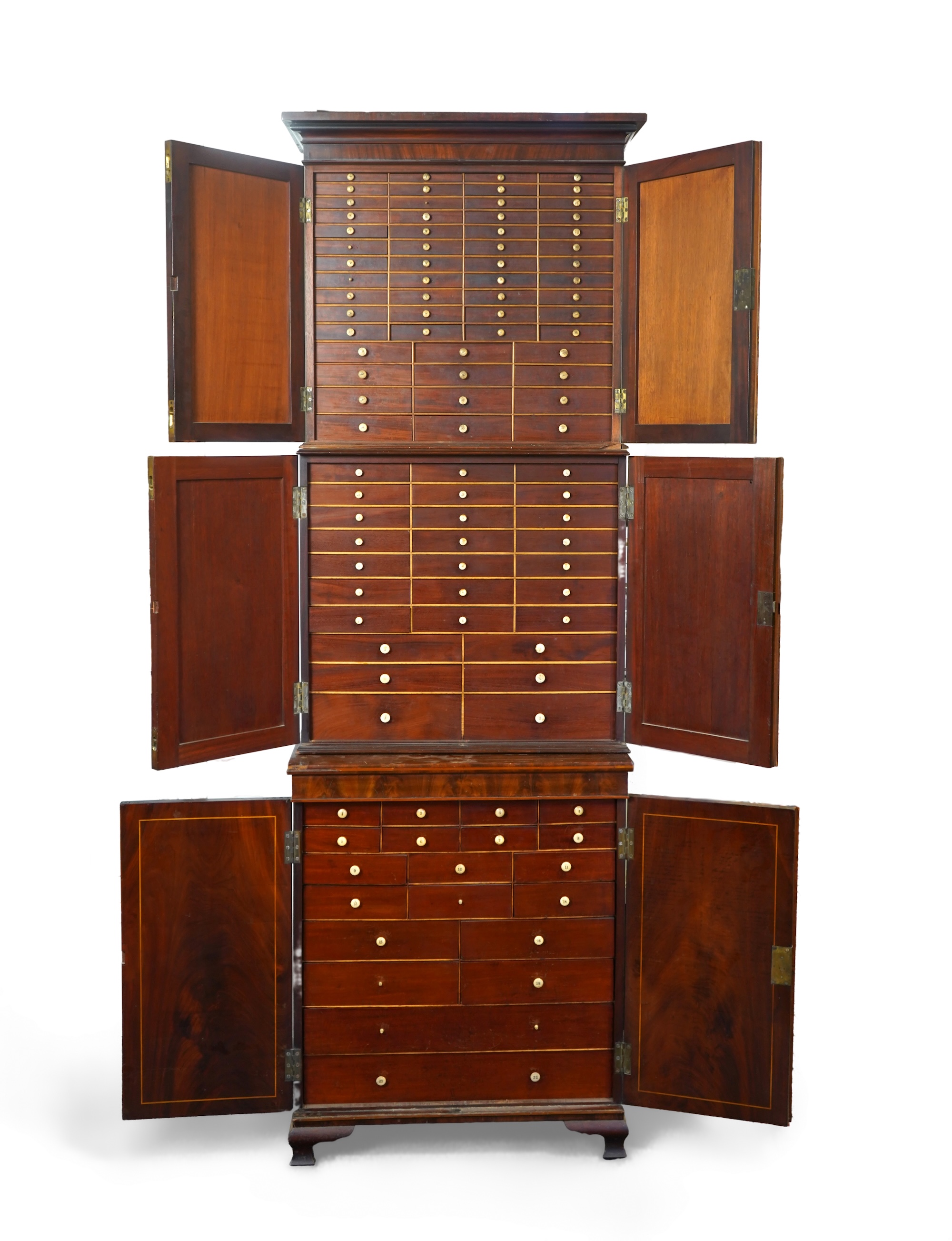 A George IV crossbanded and boxwood strung mahogany three section collector’s cabinet